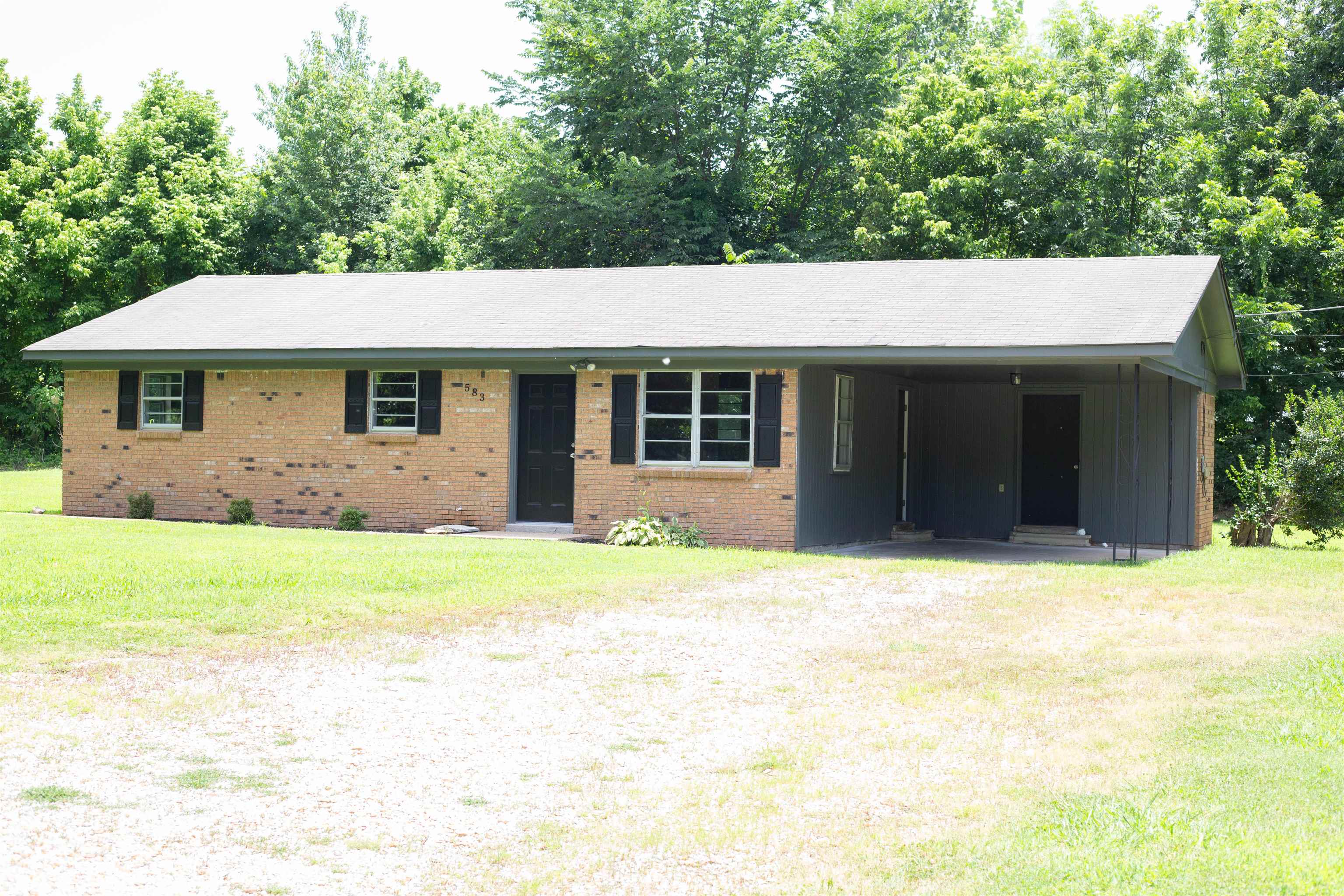 583 Armstrong Road Drummonds, TN 38023 - Photo 1 of 14 Brick exterior with black shutters and a covered carport