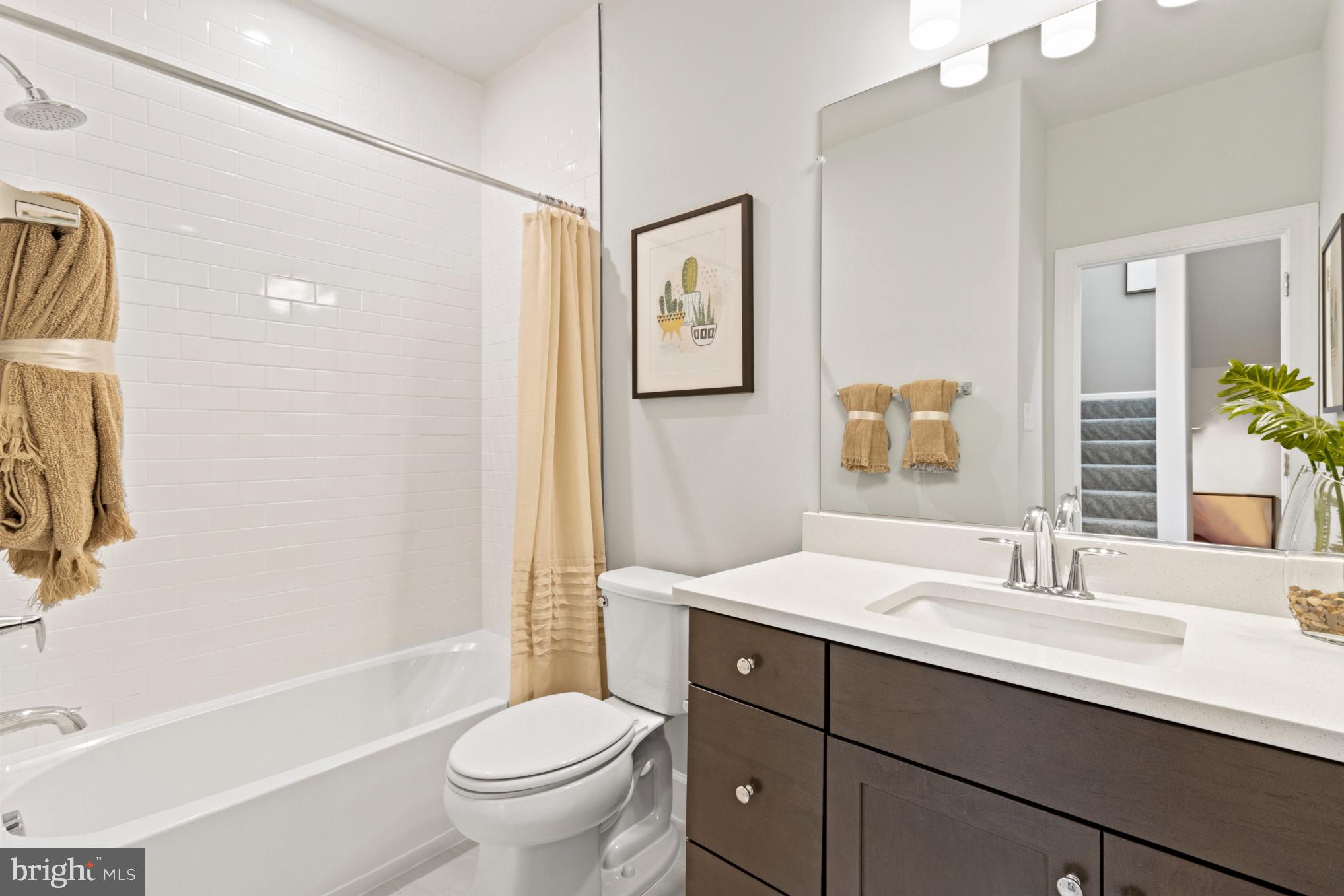 3603 St Amy Way Bowie, MD 20716 - Photo 17 of 42 a bathroom with a toilet a sink a mirror a bathtub and shower