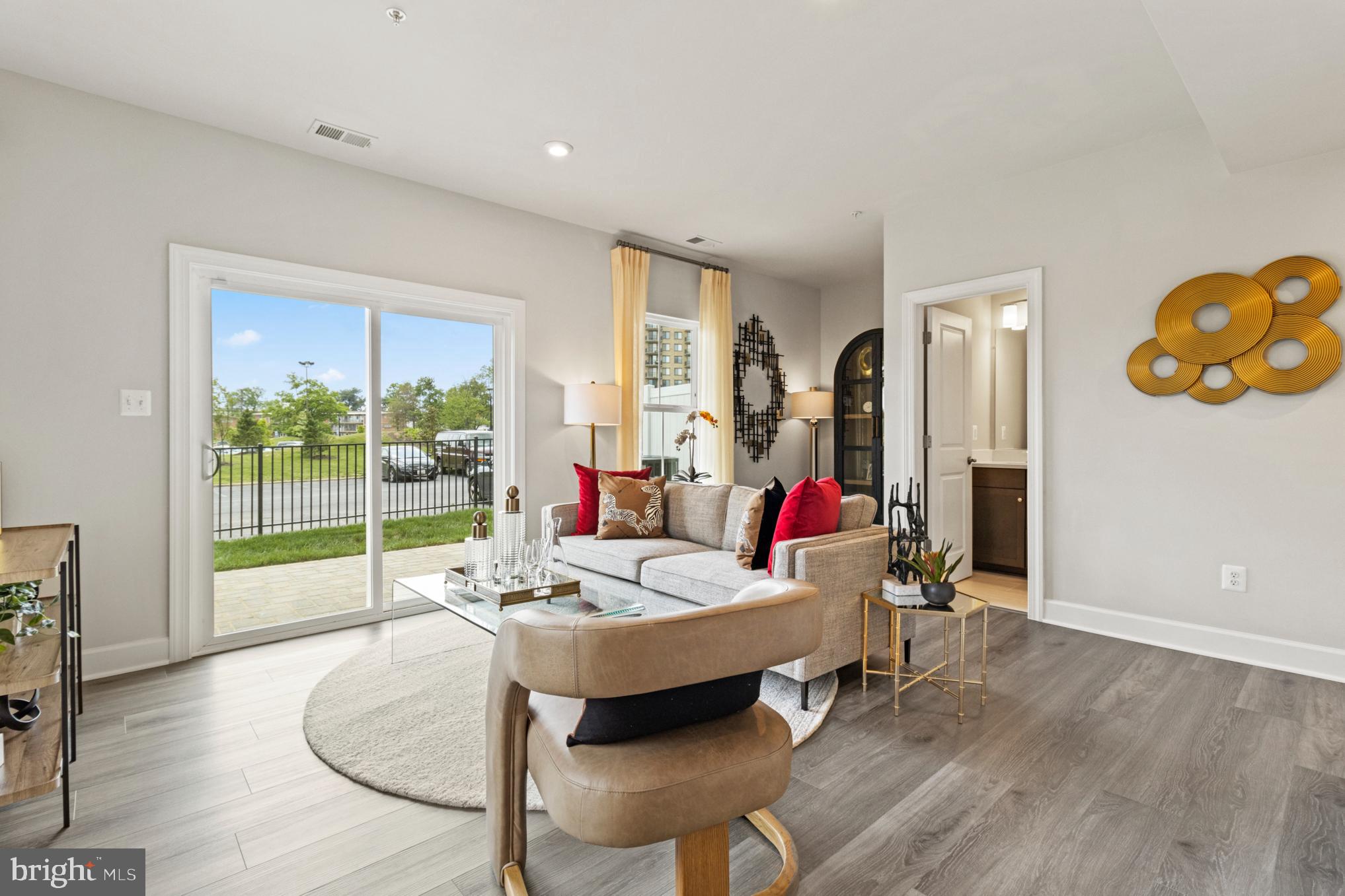 3603 St Amy Way Bowie, MD 20716 - Photo 20 of 42 a living room with furniture and a floor to ceiling window