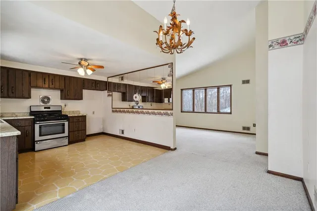 a kitchen with a stove a refrigerator and a sink