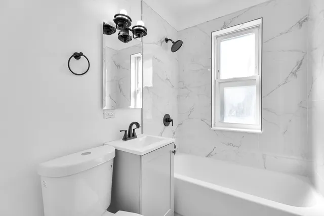 a bathroom with a sink toilet and shower