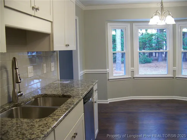 a kitchen with a refrigerator and a stove
