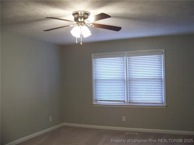 a view of a backyard space with wooden fence