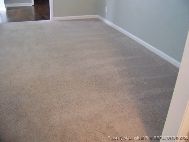 a view of empty room with fireplace