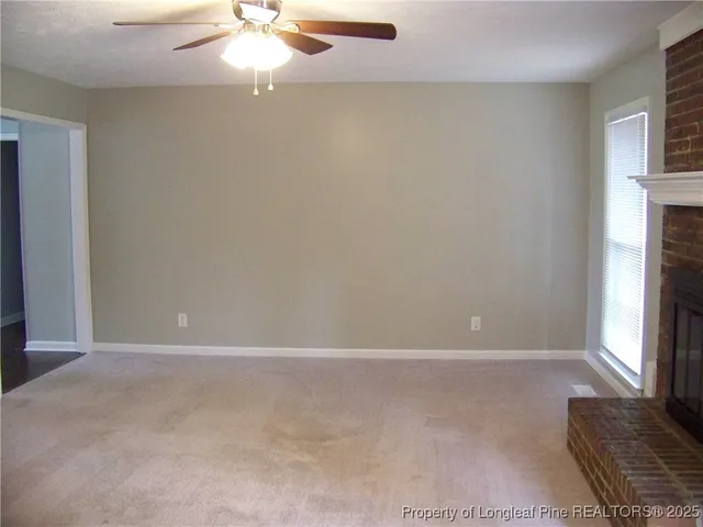 a view of empty room with fireplace