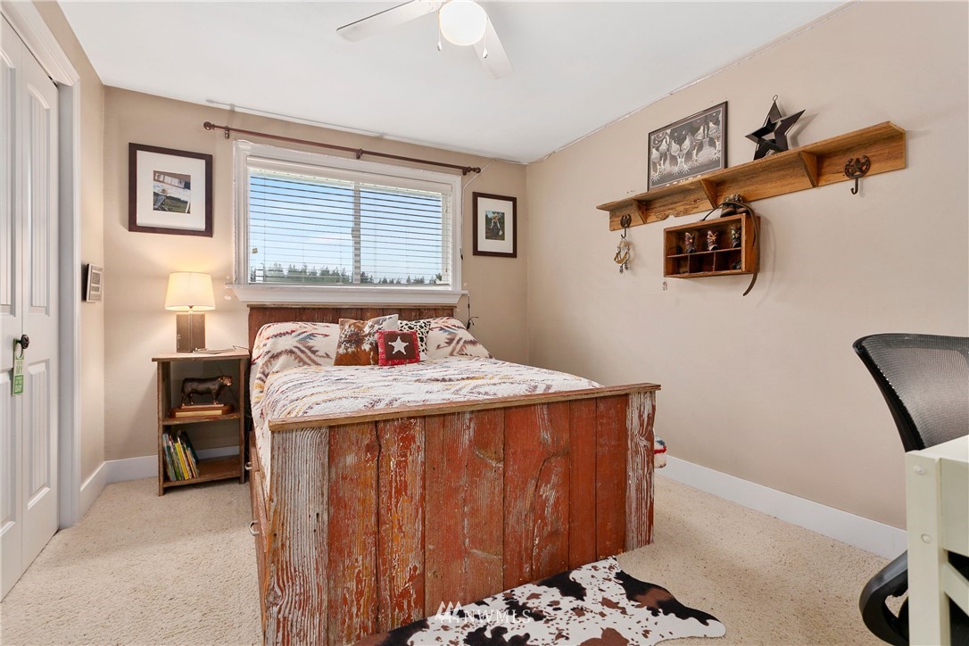 2091 Zell Road Ferndale, WA 98248 - Photo 11 of 25 a bedroom with a bed and a chair