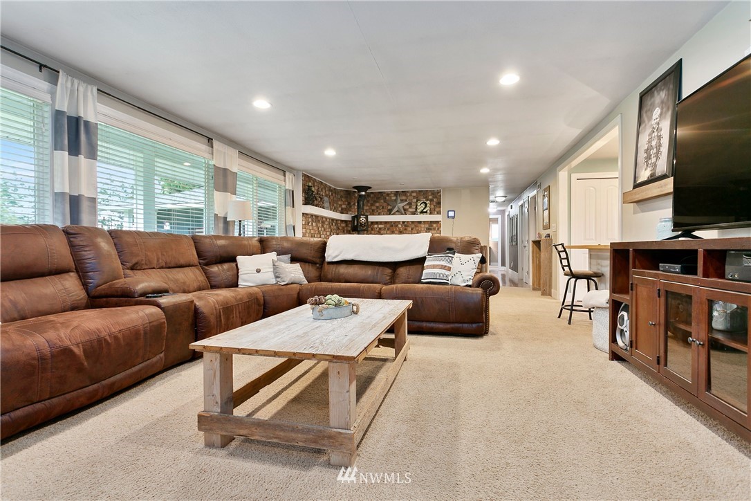 2091 Zell Road Ferndale, WA 98248 - Photo 16 of 25 a living room with furniture and a flat screen tv