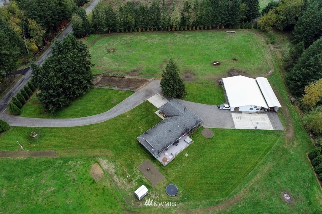 2091 Zell Road Ferndale, WA 98248 - Photo 22 of 25 a view of a garden with a large tree