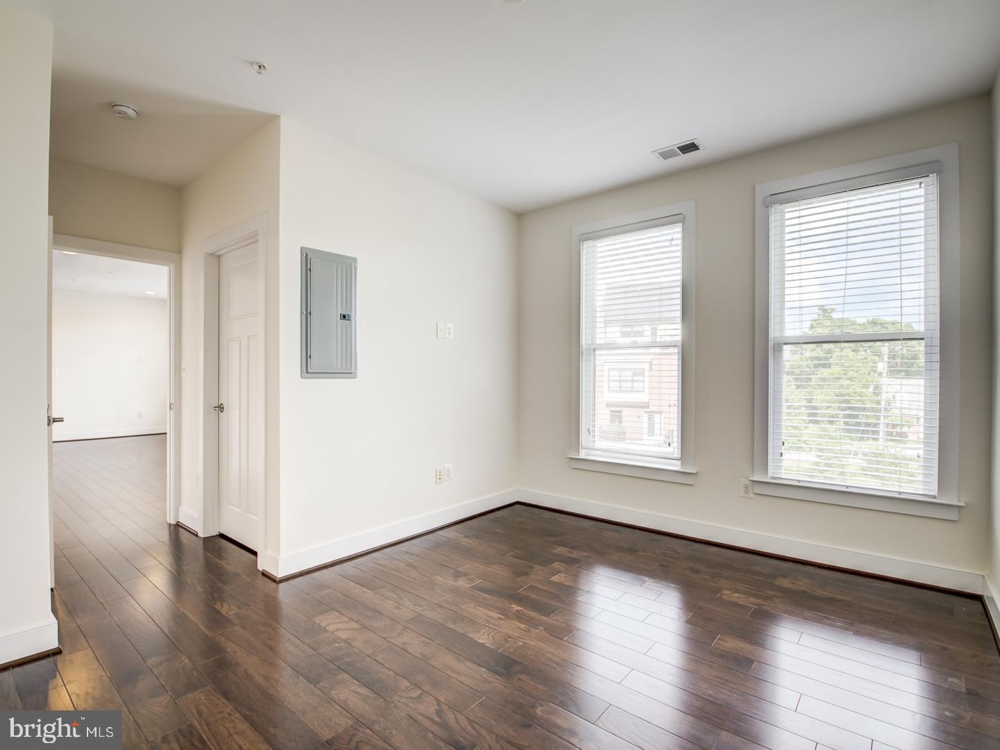 1107 South Walter Reed Drive, Unit 302 Arlington, VA 22204 - Photo 30 of 50 an empty room with wooden floor and windows