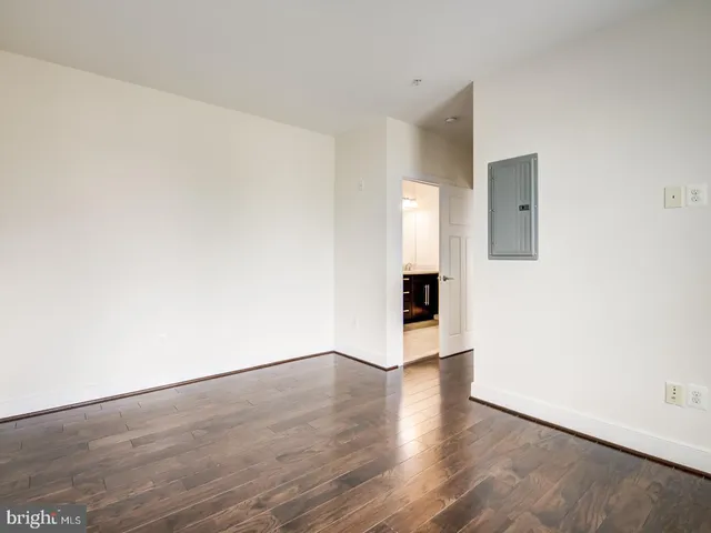 a view of an empty room with wooden floor