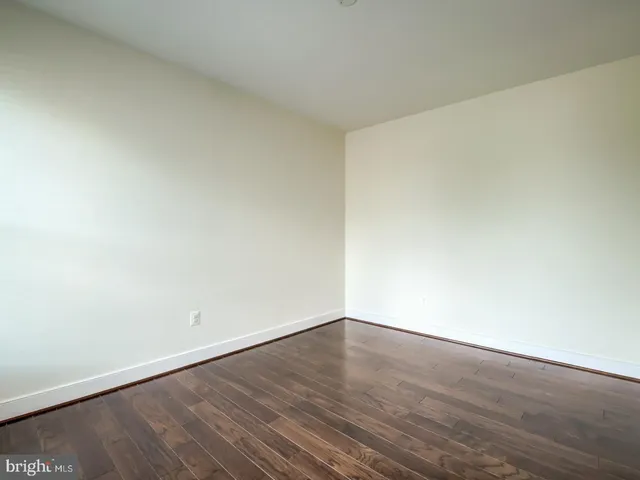 an empty room with wooden floor