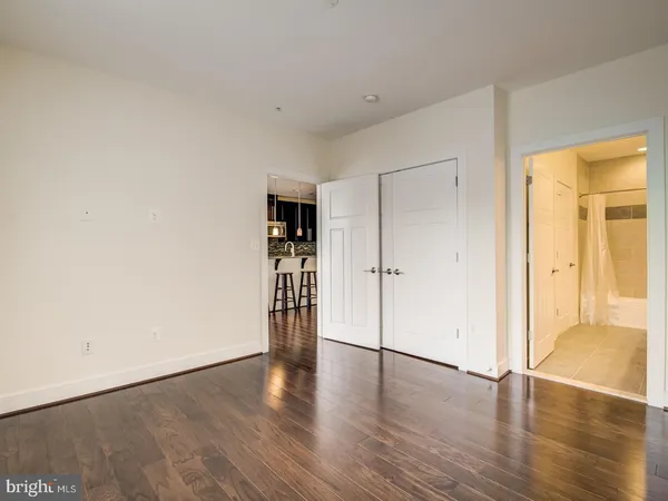 a view of an empty room with wooden floor