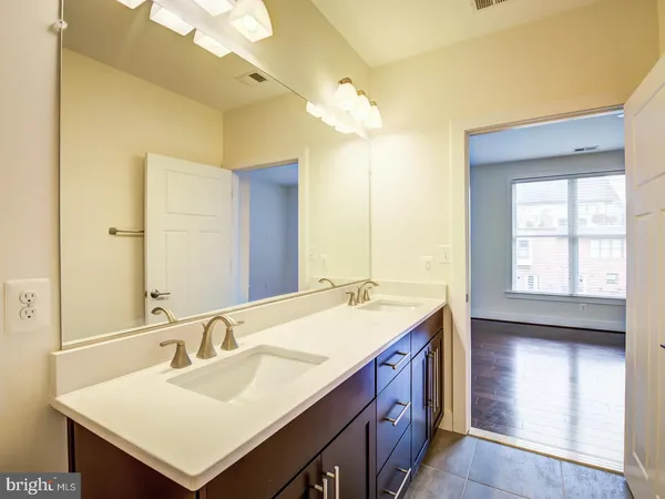 a bathroom with a sink double vanity and a mirror