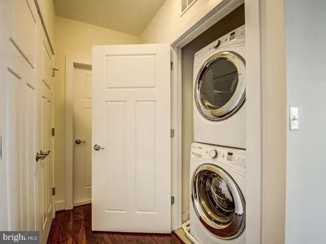 a view of a hallway with washer and dryer