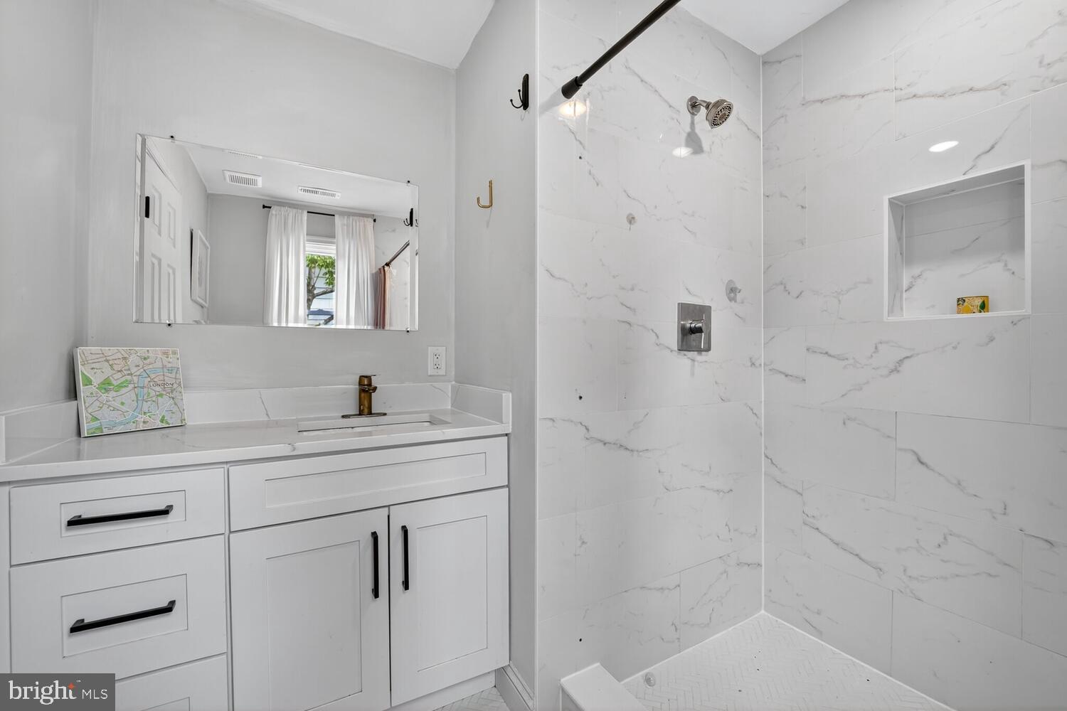 6017 Inwood Street Landover, MD 20785 - Photo 17 of 33 a bathroom with a shower sink and mirror