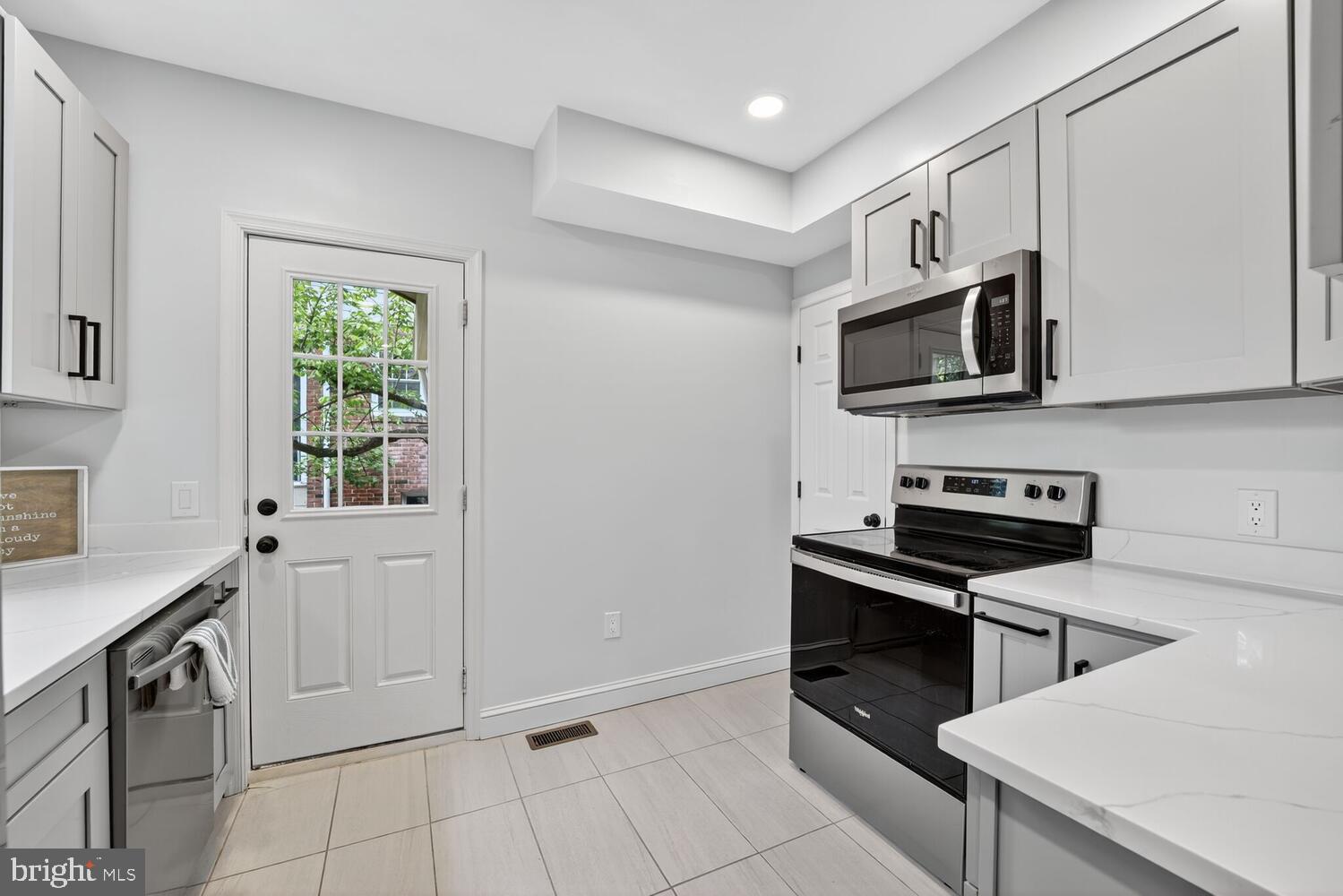 6017 Inwood Street Landover, MD 20785 - Photo 10 of 33 a kitchen with stainless steel appliances a stove microwave and sink