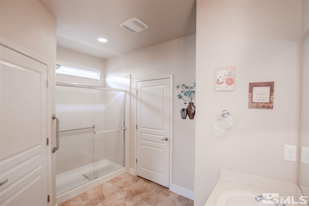 1137 Callaway Trail Reno, NV 89523 - Photo 11 of 22 a bathroom with a glass shower door