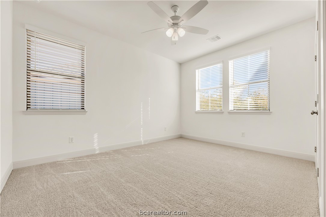 5084 Acadia Loop Bryan, TX 77802 - Photo 28 of 33 an empty room with a window and a ceiling fan