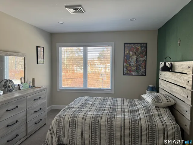a bedroom with a bed and window