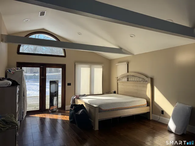 a open kitchen with stainless steel appliances kitchen island granite countertop a table chairs and a refrigerator