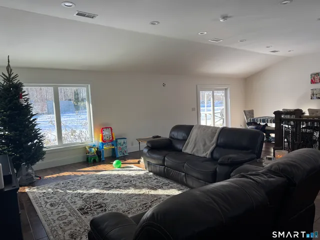 a view of a house with a yard covered with snow in the background