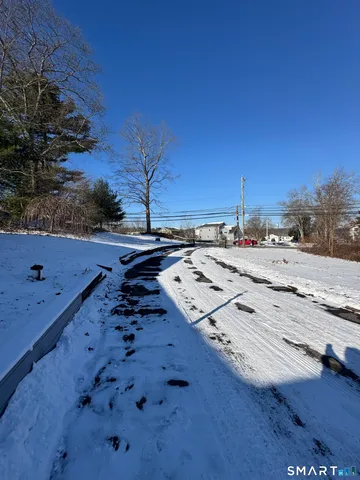 a view of hallway with couch and wooden floor