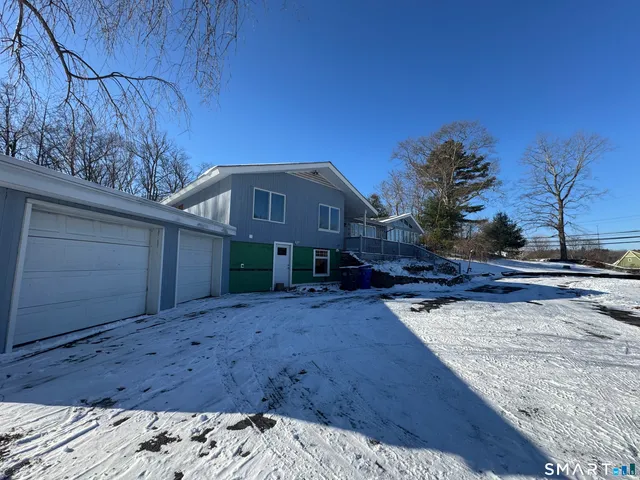 a kitchen with granite countertop a sink dining table and chairs