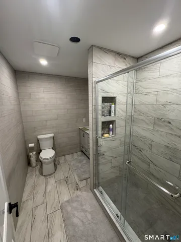 a bedroom with a bed and a dresser in it