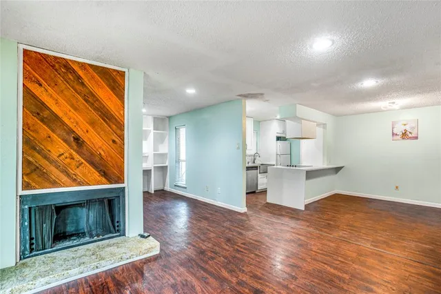 a view of a kitchen with a sink and a fireplace