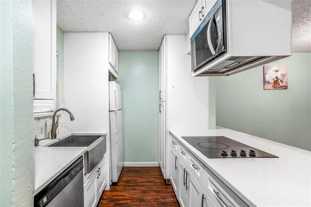 a kitchen with stainless steel appliances granite countertop a sink and a stove