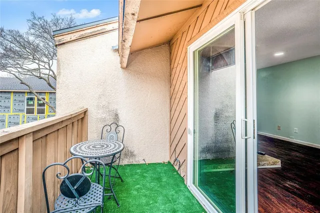 a view of a porch with furniture and a yard