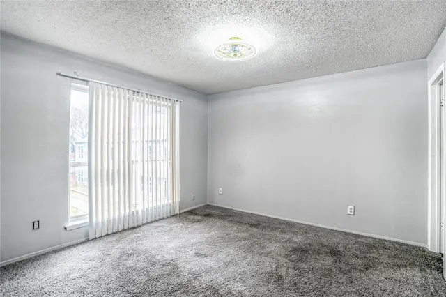 an empty room with a empty space and windows