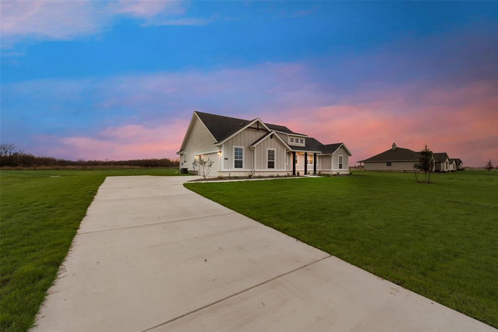 1230 County Road 200 Valley View, TX 76272 - Photo 4 of 26 Modern inspired farmhouse featuring board and batten siding, driveway, and a yard