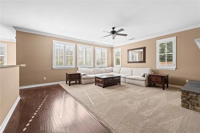 a spacious bedroom with a bed a couch and a chandelier