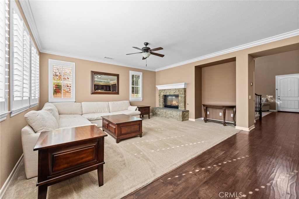 32437 Yosemite Lane Temecula, CA 92592 - Photo 18 of 63 a living room with furniture a fireplace and a table