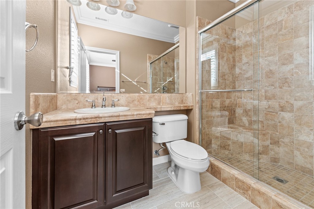 32437 Yosemite Lane Temecula, CA 92592 - Photo 27 of 63 a bathroom with a sink a toilet a mirror and shower