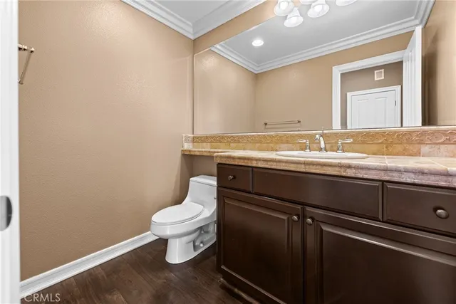 a spacious bedroom with a bed and a chandelier