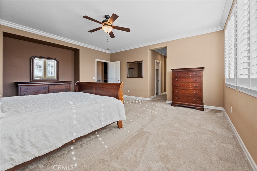 32437 Yosemite Lane Temecula, CA 92592 - Photo 35 of 63 a bedroom with a large bed and a chandelier