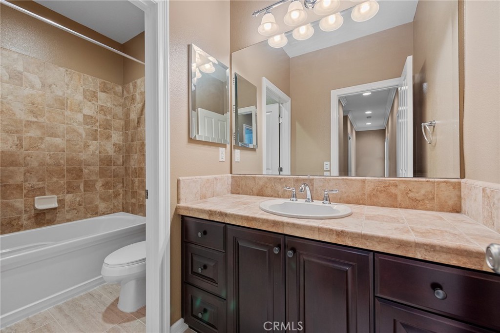 32437 Yosemite Lane Temecula, CA 92592 - Photo 48 of 63 a bathroom with a granite countertop sink toilet and shower