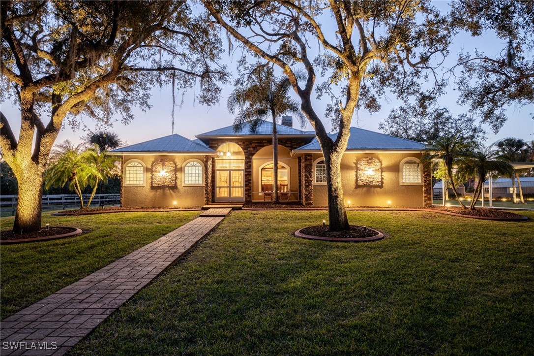 12251 Old Rodeo Drive Alva, FL 33920 - Photo 1 of 49 a front view of a house with a yard
