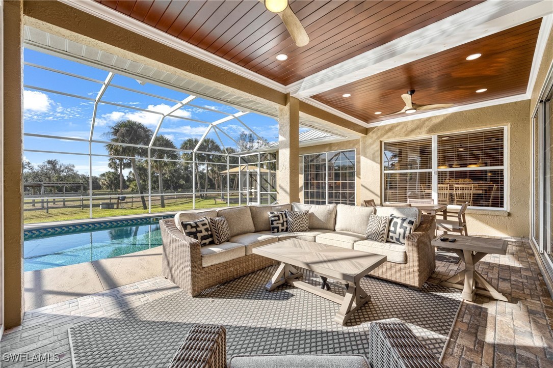 12251 Old Rodeo Drive Alva, FL 33920 - Photo 12 of 49 a living room with patio furniture and a floor to ceiling window