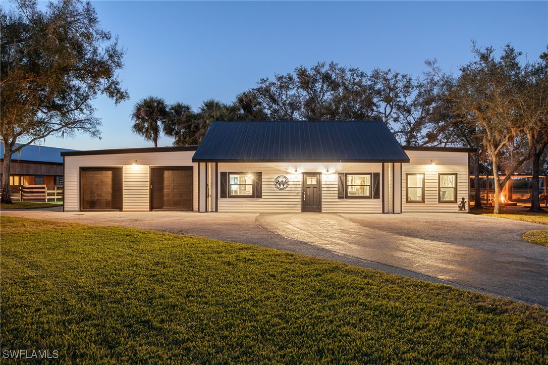 12251 Old Rodeo Drive Alva, FL 33920 - Photo 16 of 49 a view of a house with a yard and tree s