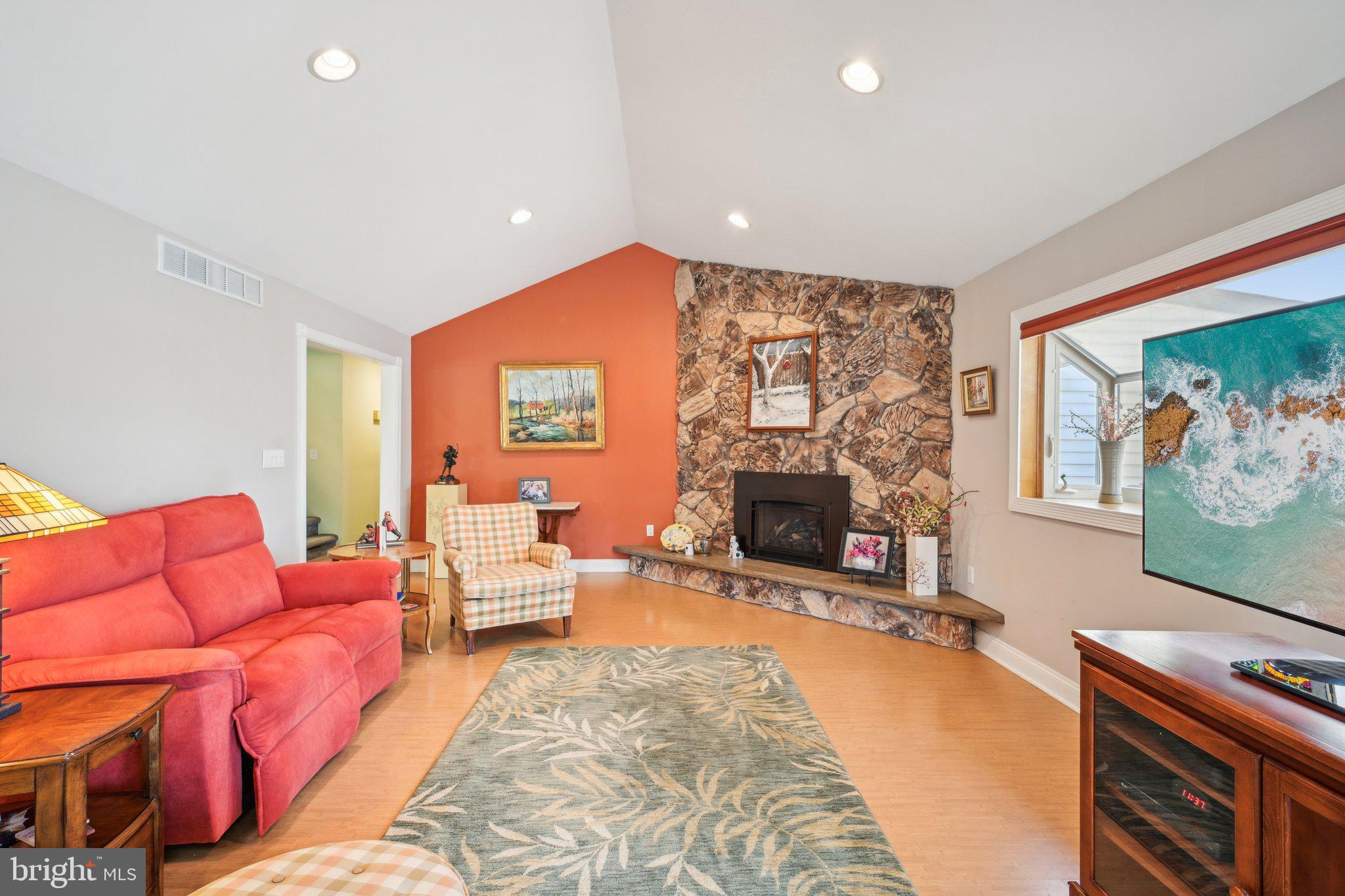 205 Lehigh Road South Glassboro, NJ 08028 - Photo 17 of 51 a living room with furniture a fireplace and a flat screen tv