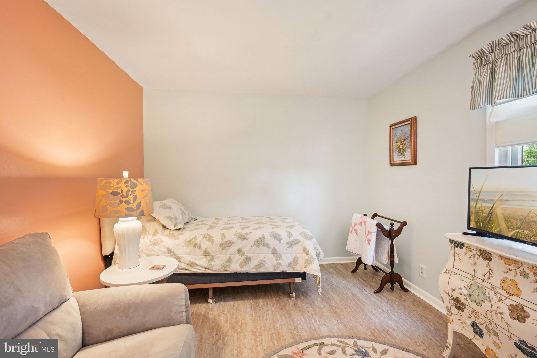 205 Lehigh Road South Glassboro, NJ 08028 - Photo 33 of 51 a bedroom with furniture and a flat screen tv