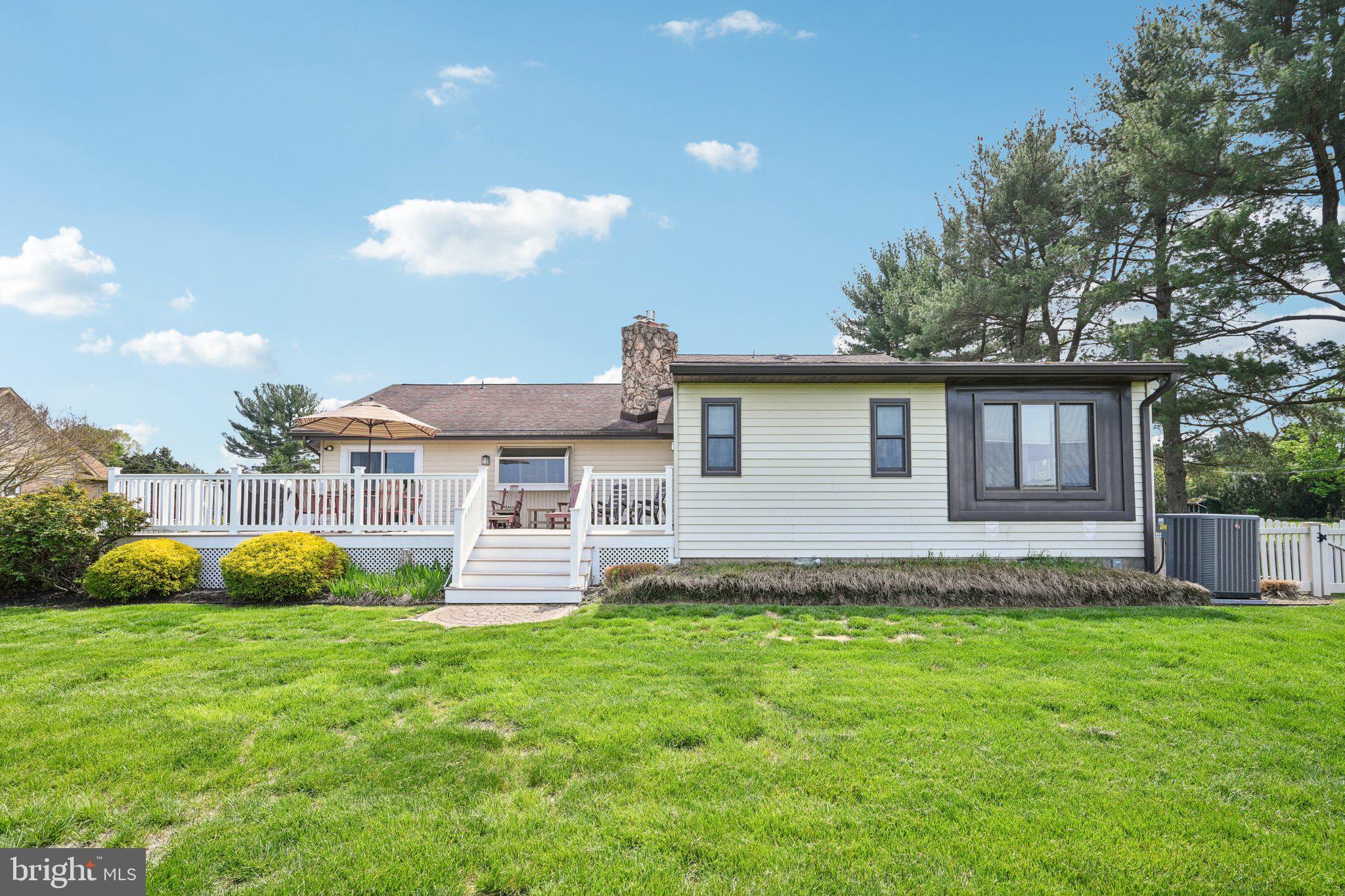 205 Lehigh Road South Glassboro, NJ 08028 - Photo 7 of 51 a front view of a house with a garden and yard