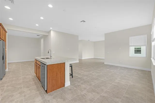 a kitchen with granite countertop a sink and a stove top oven
