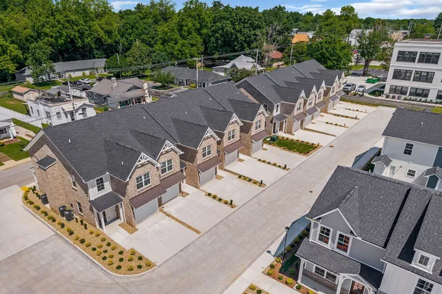 an aerial view of a house with a swimming pool outdoor seating and yard