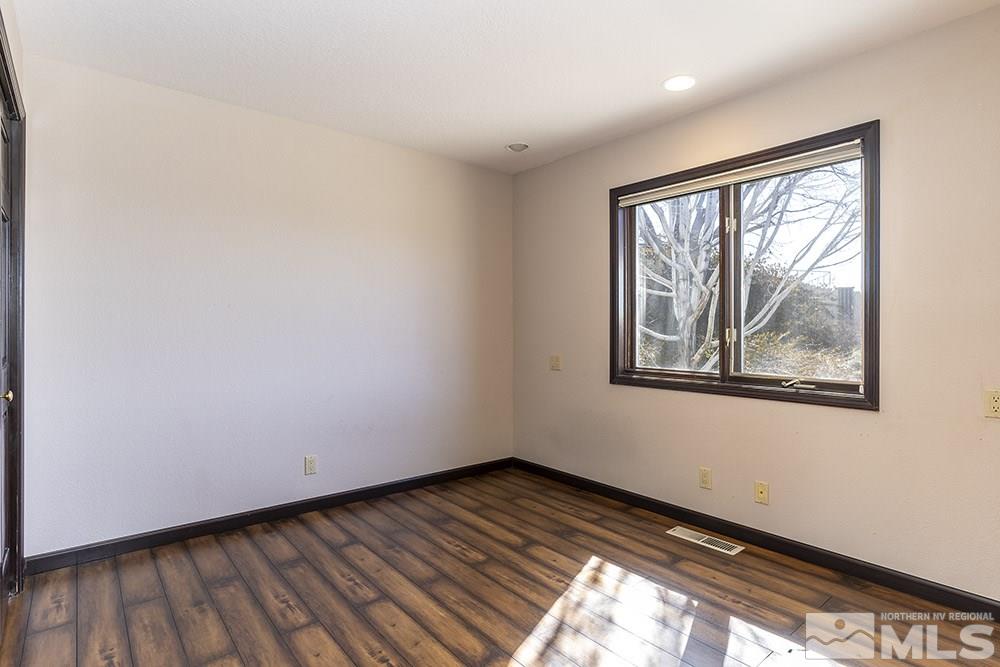725 Arius Court Reno, NV 89512 - Photo 13 of 27 wooden floor in an empty room with a window