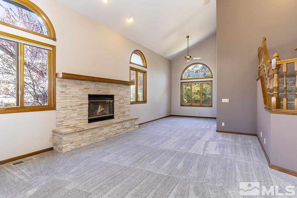725 Arius Court Reno, NV 89512 - Photo 5 of 27 an empty room with windows and fireplace