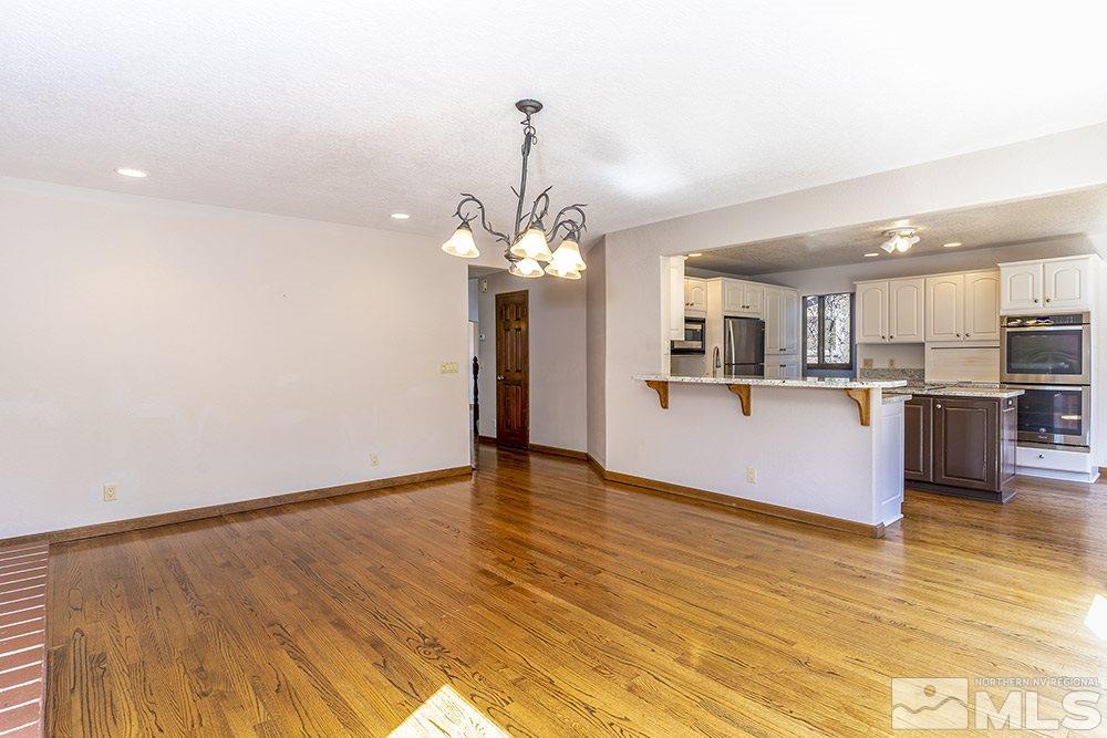 725 Arius Court Reno, NV 89512 - Photo 9 of 27 a view of a kitchen with wooden floor and a kitchen